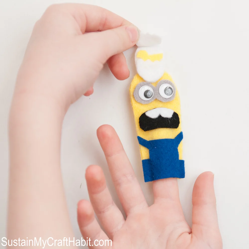 Child playing with minions felt finger puppet