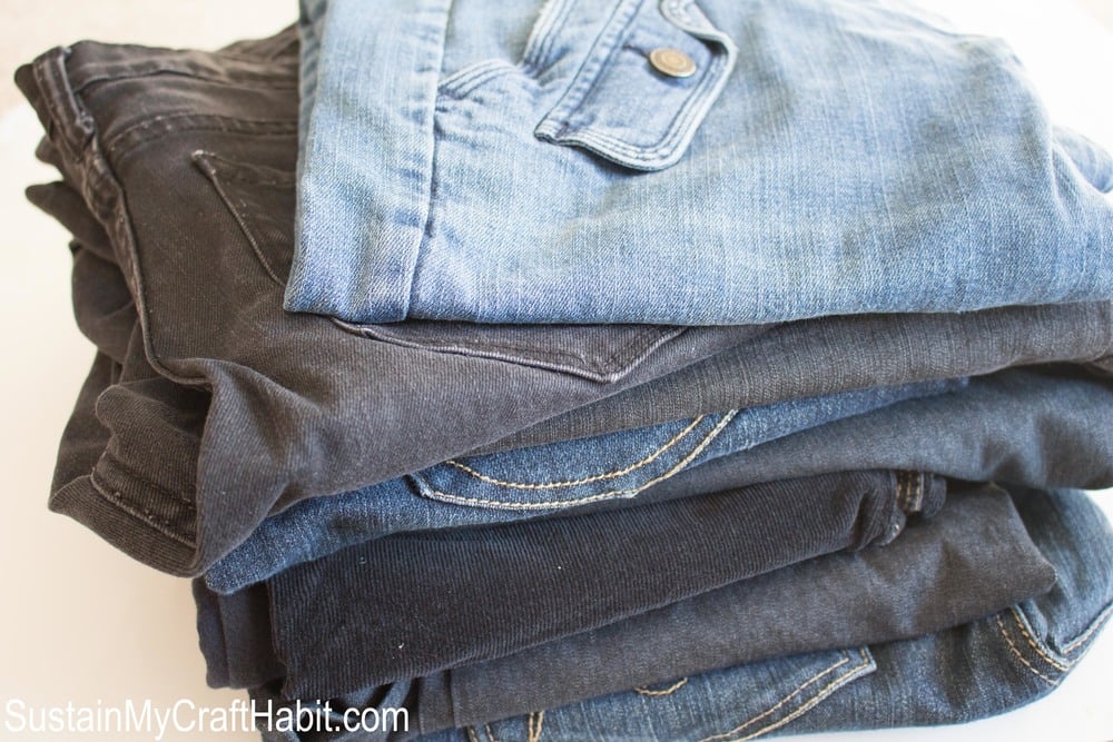 Stack of old jeans used to make a checkered denim picnic blanket.