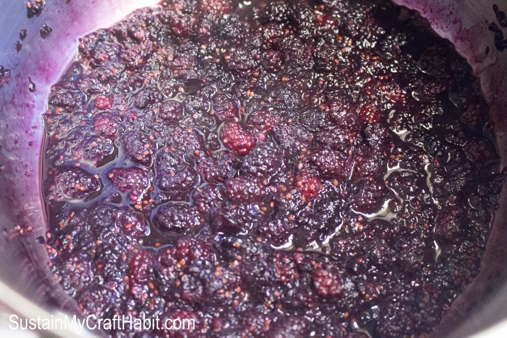 A saucepan filled with ingredients simmering to make the mulberry jam.
