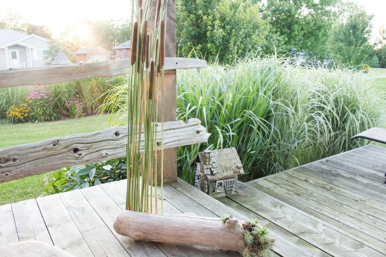 Natural porch decor idea made wiht driftwood and cattails plus over a dozen other driftwood craft ideas.