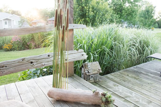 Natural porch decor idea made wiht driftwood and cattails plus over a dozen other driftwood craft ideas.