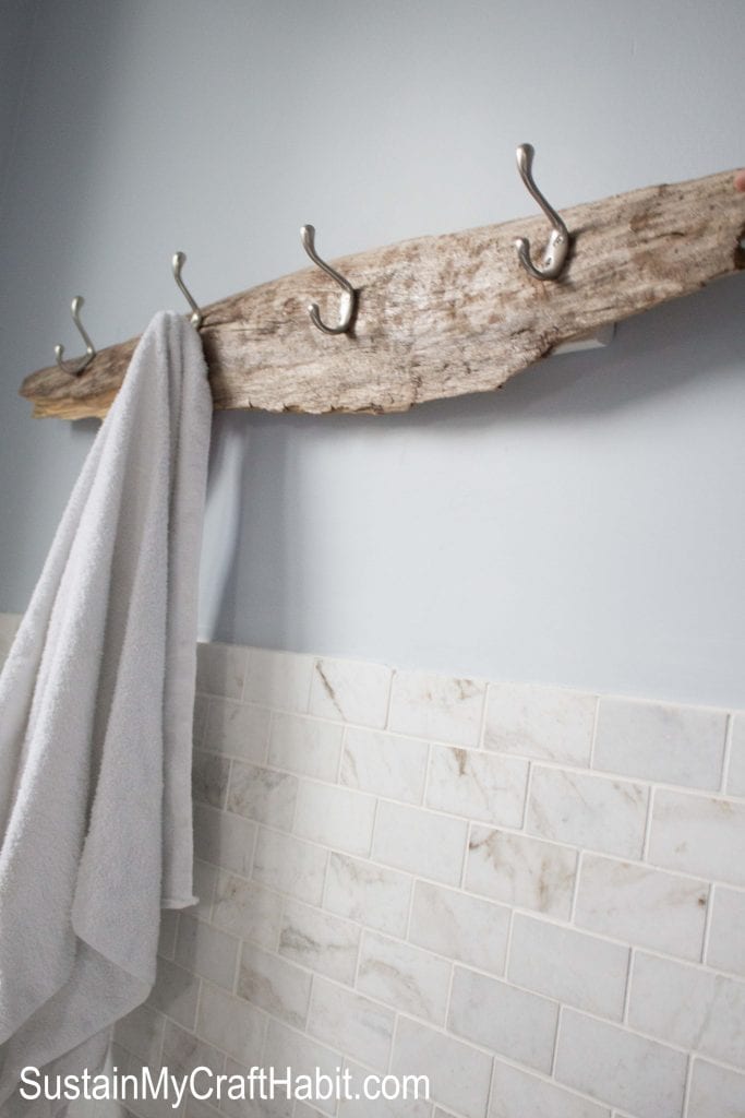 Driftwood and aprons hanging from beach house coat rack stock photo