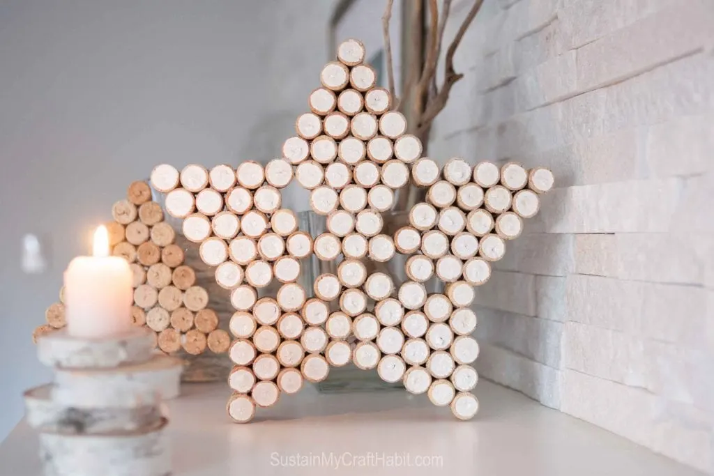 Wine cork craft ideas including a large star and wine cork Christmas tree on a neutral holiday mantle 