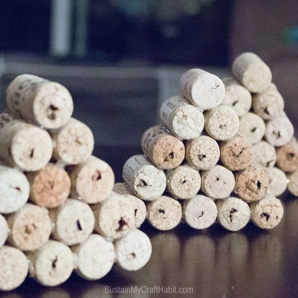 Three groupings of wine cork triangles which look like Christmas trees