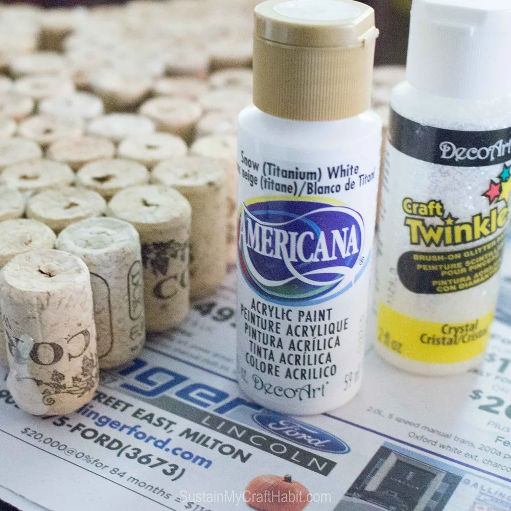 White acrylic paint used to paint the surface of the wine corks for this wine cork crafts idea