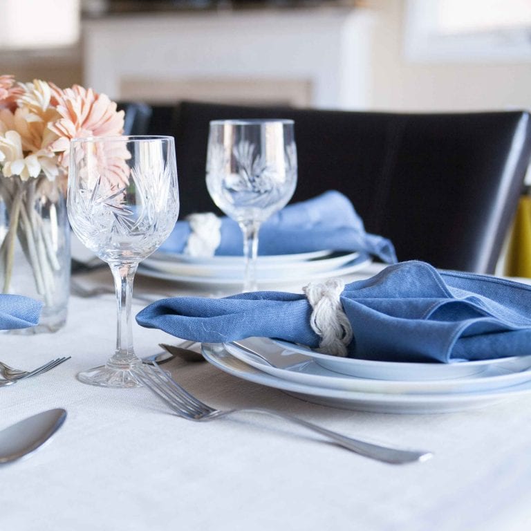 DIY Irish linen napkins with a frayed hem finish and nautical-inspired sailor-cable napkin rings. A step-by-step tutorial is included as well as a video for making the napkin rings. These would be perfect for any coastal or nautical themed event such as a dinner party, wedding reception or shower. Click through for all the details as well as links to 11 other crafts you can make with 1 yard of fabric.