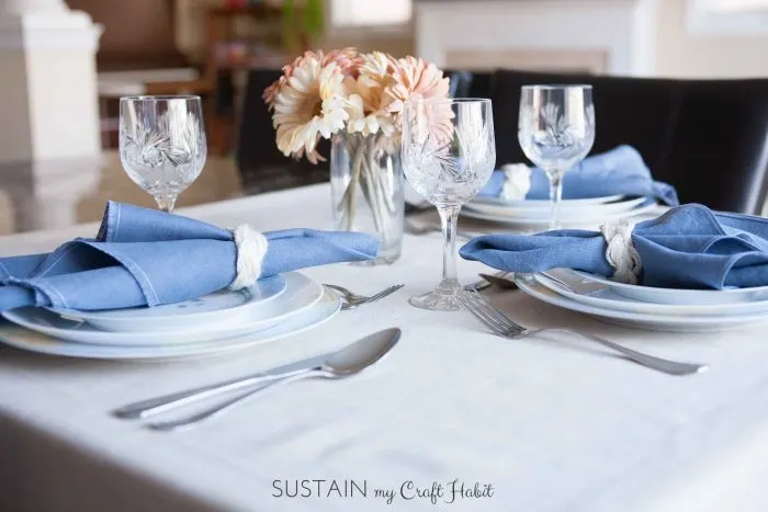 DIY Irish linen napkins with a frayed hem finish and nautical-inspired sailor-cable napkin rings. A step-by-step tutorial is included as well as a video for making the napkin rings. These would be perfect for any coastal or nautical themed event such as a dinner party, wedding reception or shower. Click through for all the details as well as links to 11 other crafts you can make with 1 yard of fabric.