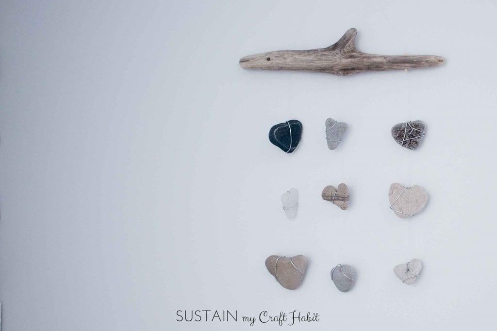 Driftwood, sea glass and beach stones wall hanging nautical decor idea.