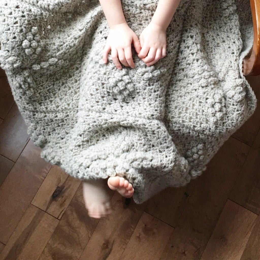 Make a beautiful wool afghan with this free crochet pattern for a sand pebbles diamond square design by SustainMyCraftHabit.