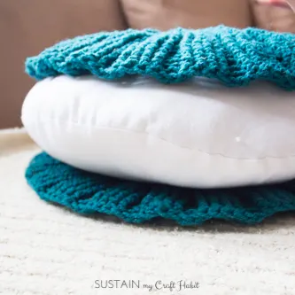 Stacking of the covers of the crochet pillow over the round pillow form