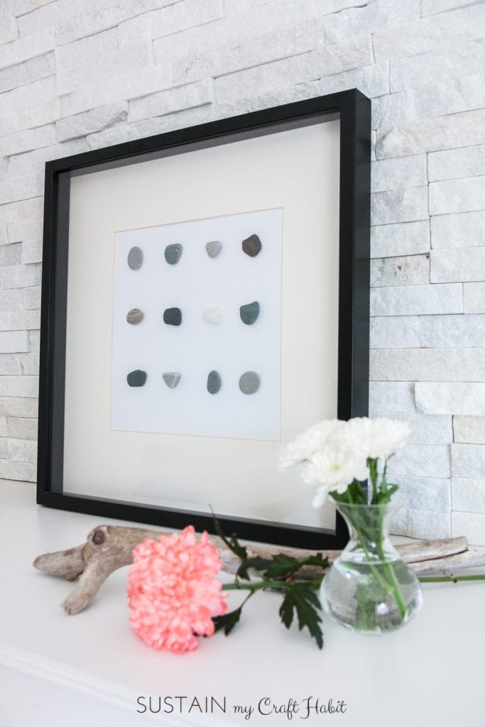 DIY wall art. Make beautiful and natural art for your wall simply with stones and glue. A lovely DIY home decor idea for your coastal or rustic home. Click through for the tutorial.