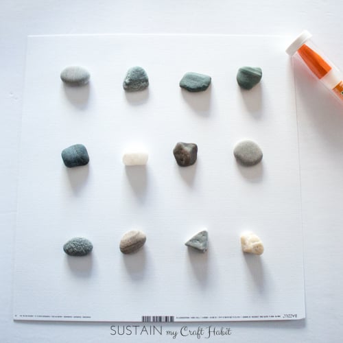 Arranging the beach stones onto the white cardstock backing