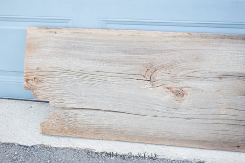 Close up image of one end of the piece of barn wood showing a large crack