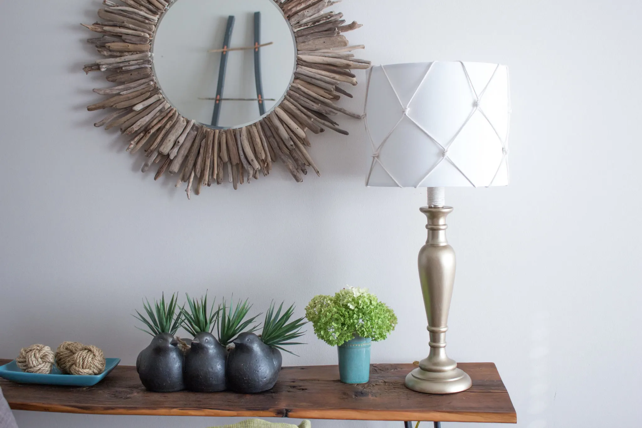 An outdated old table lamp for the living room got a fresh nautical makeover using DecoArt Americana Metallic Paint and a simple DIY fish net lampshade.
