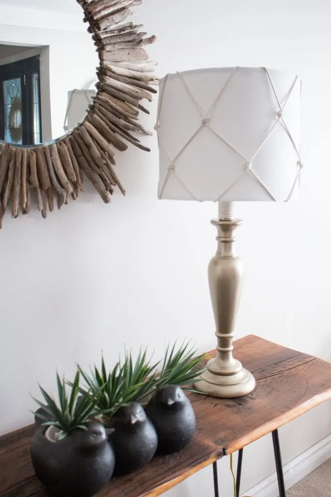An outdated old table lamp for the living room got a fresh nautical makeover using DecoArt Americana Metallic Paint and a simple DIY fish net lampshade.