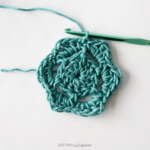Finishing the third round of how to make a crochet coaster tutorial