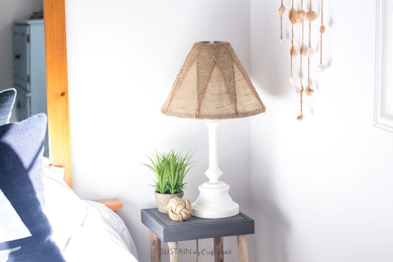 Learn how to makeover an old brass lamp base and outdated shade simply using some spray paint and burlap ribbon.
