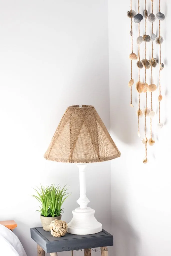 Learn how to makeover an old brass lamp base and outdated shade simply using some spray paint and burlap ribbon.