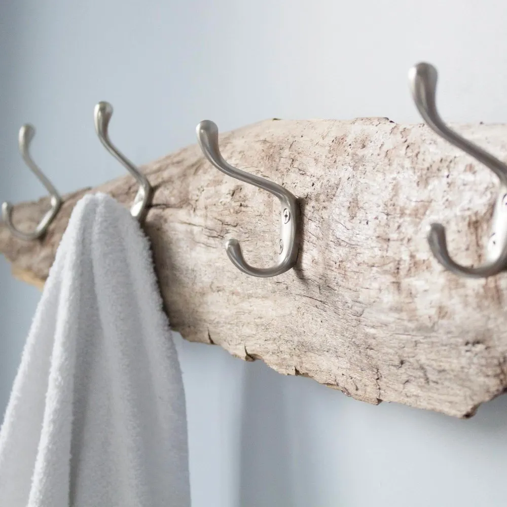 Make a handy towel rack with a piece of driftwood and some hardware store hooks. 