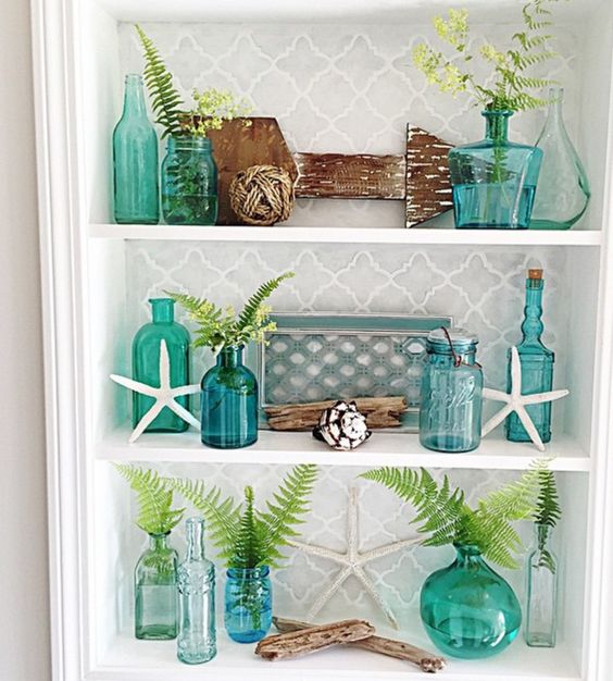 Aqua and teal accessories on a coastal bathroom shelf