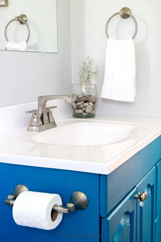 DIY ideas for a beach themed bathroom. Upcycled vanity, new counters and a faucets in this small bathroom remodel tour.