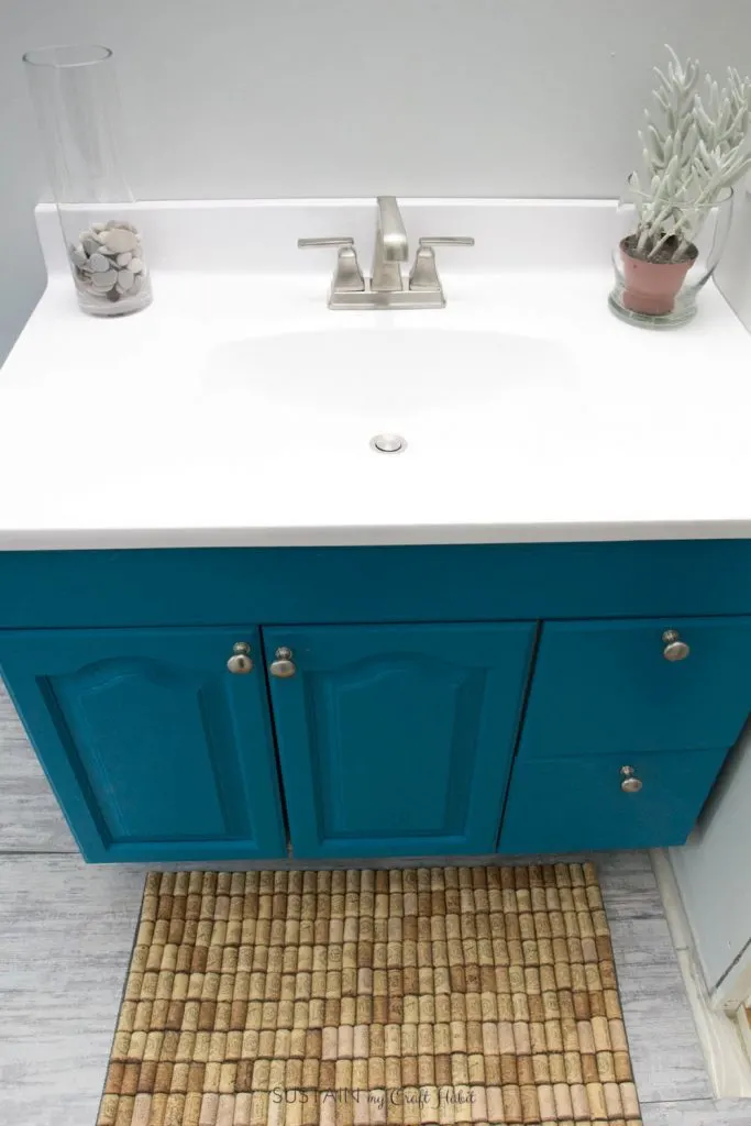 Beach themed bathroom vanity upcycled with teal paint and new countertop.