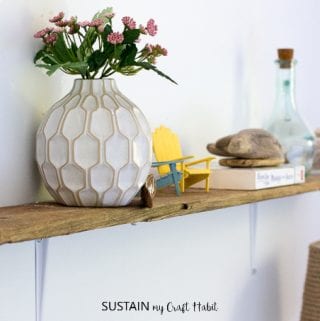 DIY shelves made with driftwood and inexpensive hardware store wall brackets.