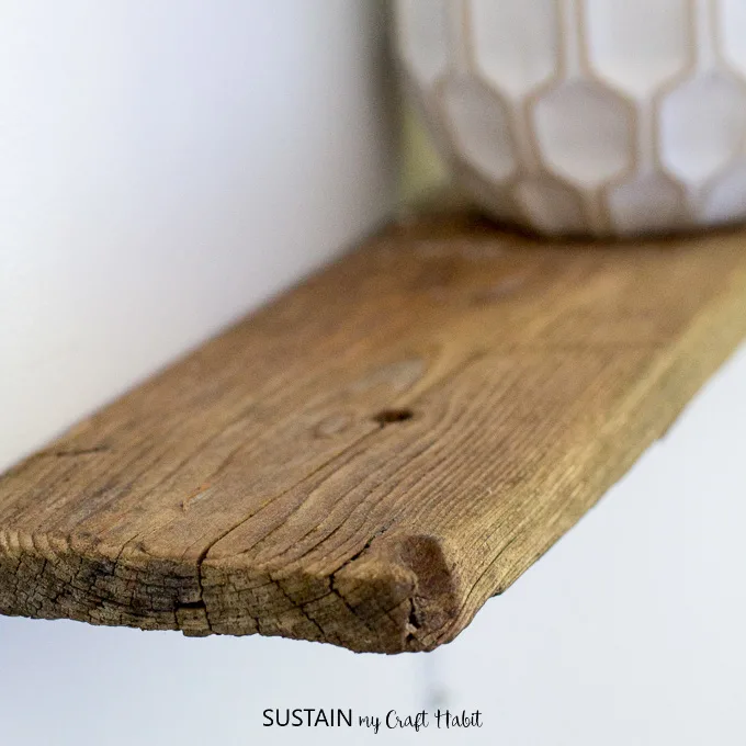 Close up view of the grain of the driftwood used to make the rustic shelf.