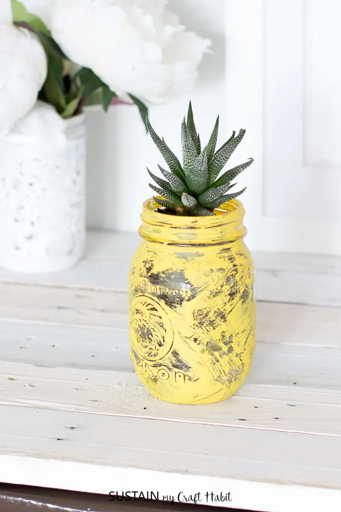 Add a touch of pineapple to your home with this easy DIY succulent planter. A fun upcycling craft idea!