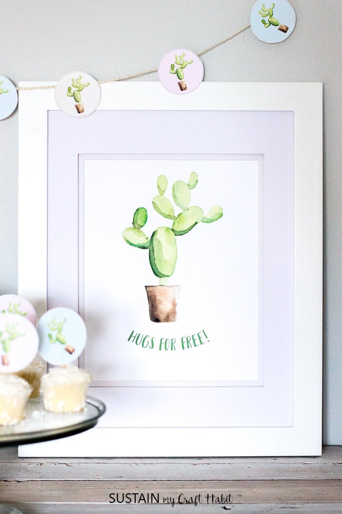 Adorable watercolor cactus wall art! Grab this free printable "Hugs are free" piece of art for your home or office.