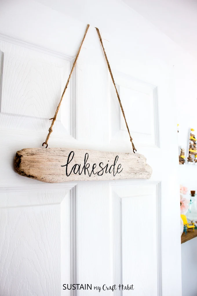 Make these DIY driftwood signs for your home or cottage. With a brush-lettering trick that'll make your lettering look like a pro. Full tutorial included.