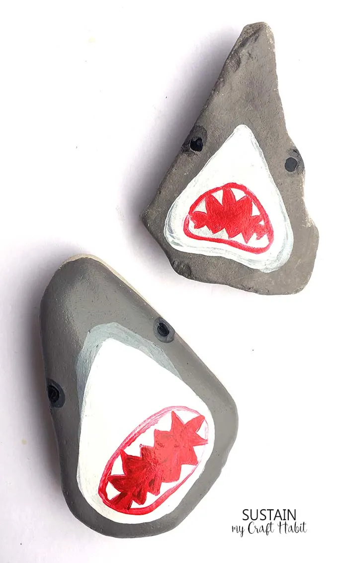 So great! Learn how to paint these hilarious shark heads on rocks! Perfect rock painting craft for the summer!