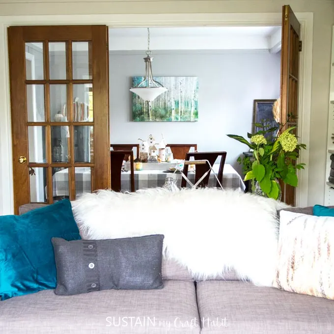 Gorgeous rustic chic living room decorated for fall featuring natural elements and touches of teal.
