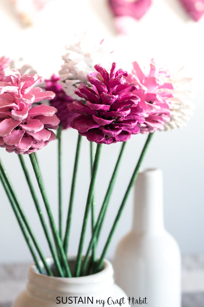 Close up image of pink and white painted pine cone flowers