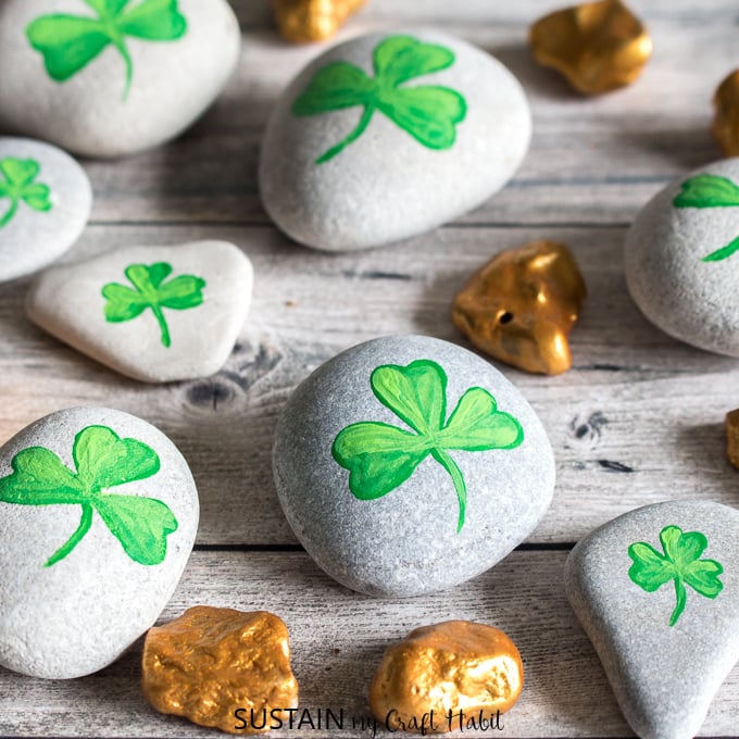 Beach stones painted as gold nuggets and shamrocks as examples of st. patrick's day crafts