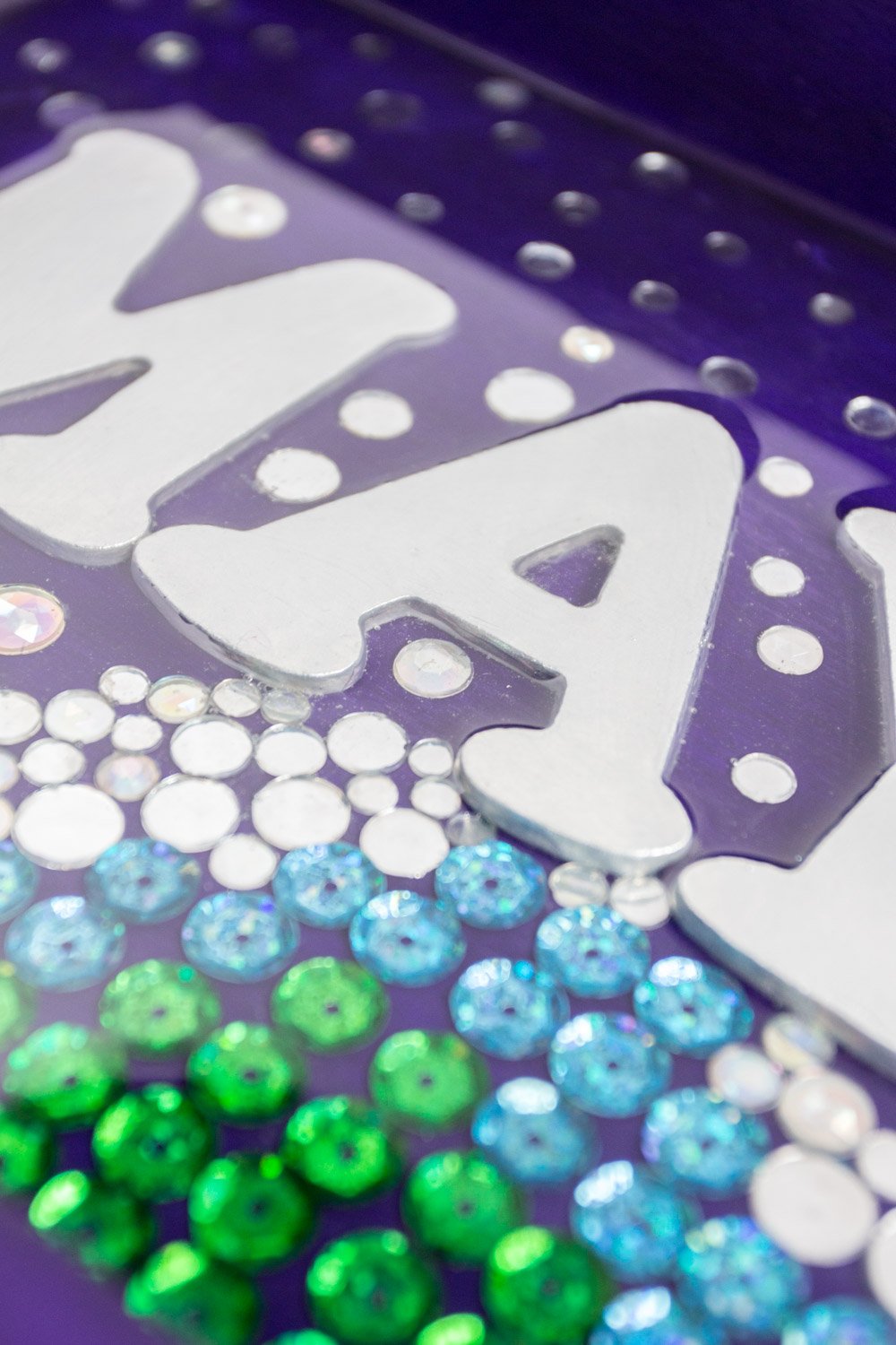 Close up image of sequins and gems embedded in EnviroTex Lite resin