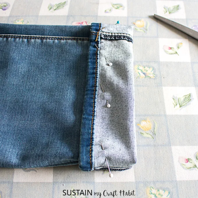 pin hem in place to shorten jeans while keeping the original hem