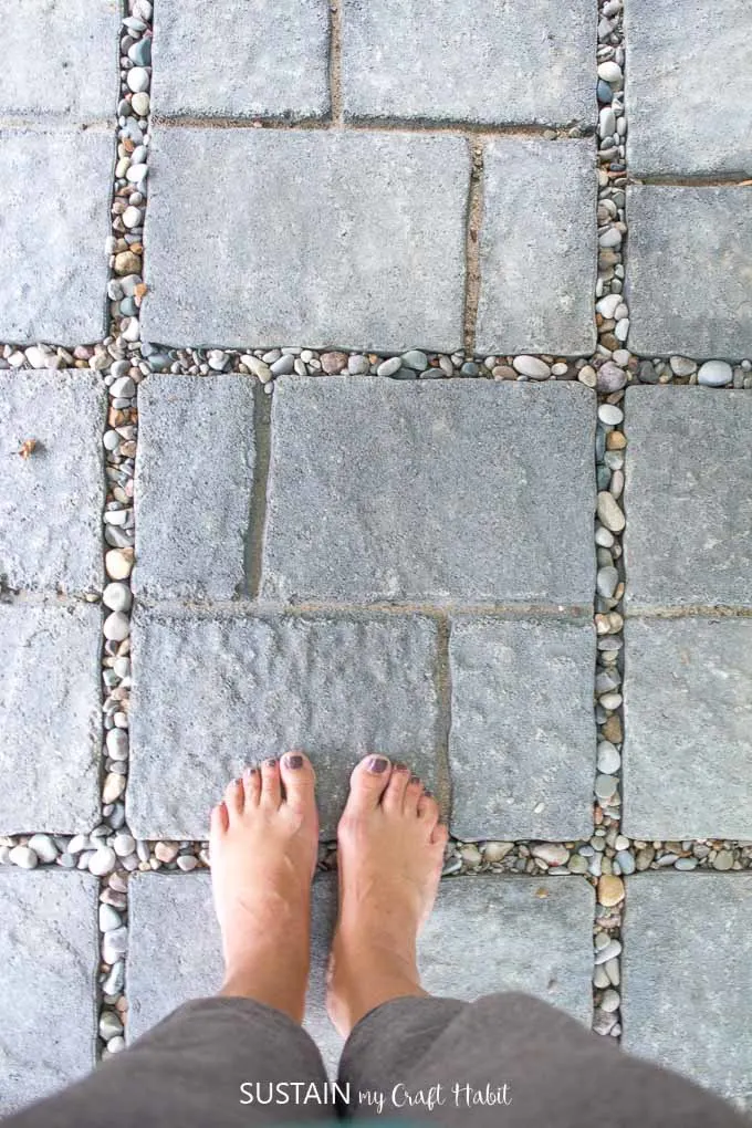 Top-down view of gray patio stones from an outdoor shower