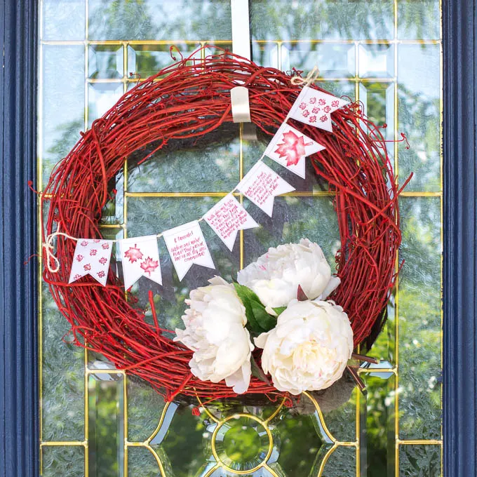 Red and white wreath on a front door to celebrate Canada Day