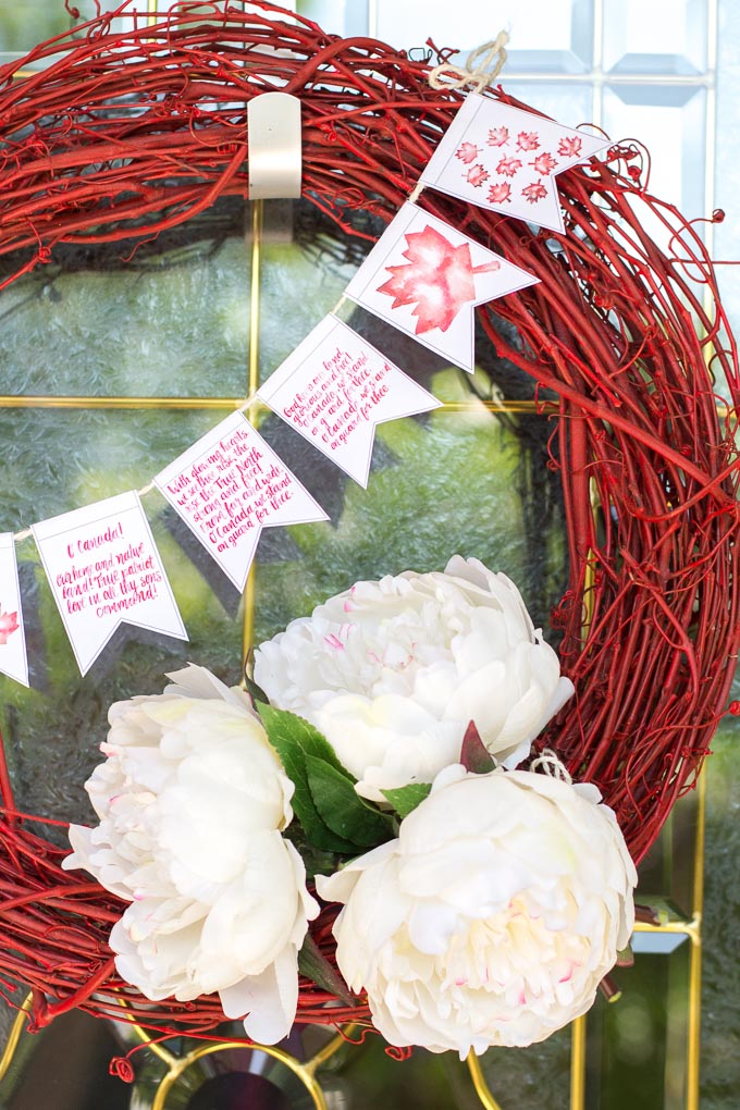 Red grapevine wreath with white flowers and mini Canada Day banner