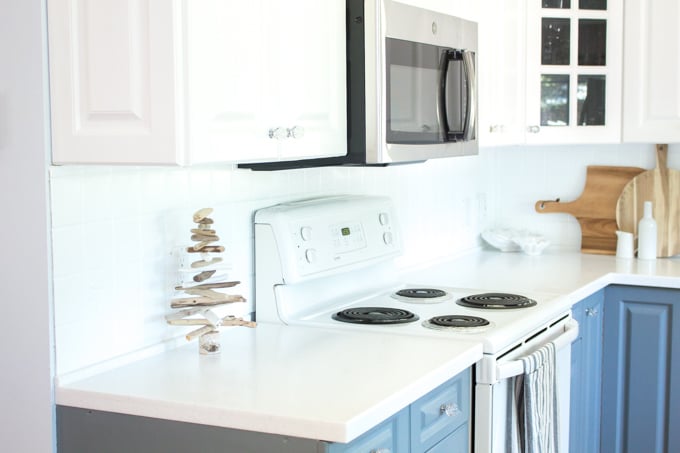 View of the painted tile backsplash behind a stove in the kitchen.