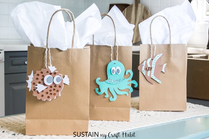 Blowfish, octapus and clownfish printable gift tags on brown craft paper gift bags with white tissue paper