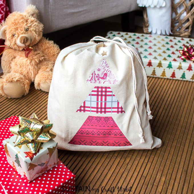 A reusable Christmas gift bag made with the Cricut EasyPress 2 and patterned heat transfer vinyl paper.