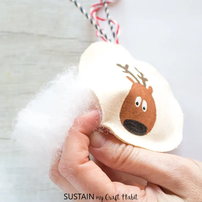 Stuffing a sew reindeer Christmas ornament with poly fill