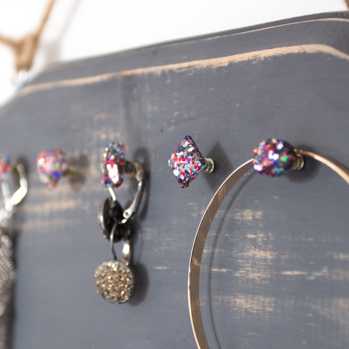 Up close image of glittering resin posts on a wood plaque to hold jewellery