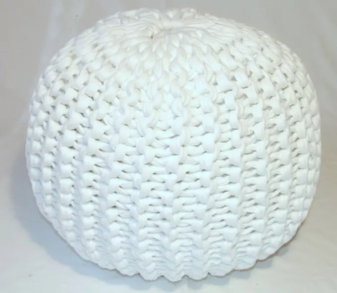 A round knitted pouf made with white tshirt yarn