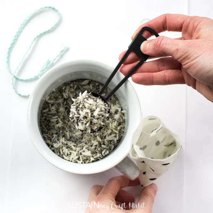 Mixing together lavender and rice in a small white bowl.