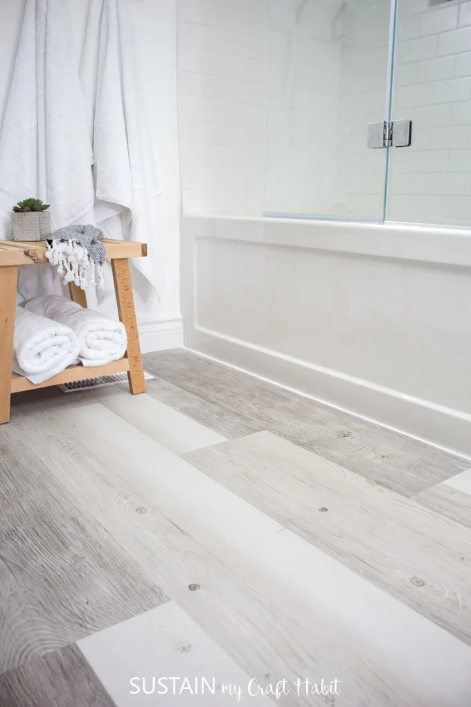 Image of the bathroom after installing vinyl plank flooring over the tile