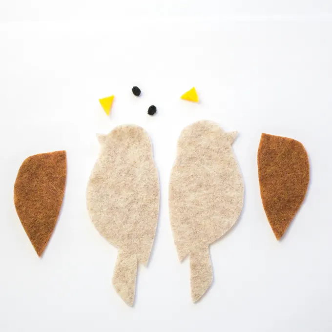 Cut out pieces of felt to make one brown felt bird bookmark.
