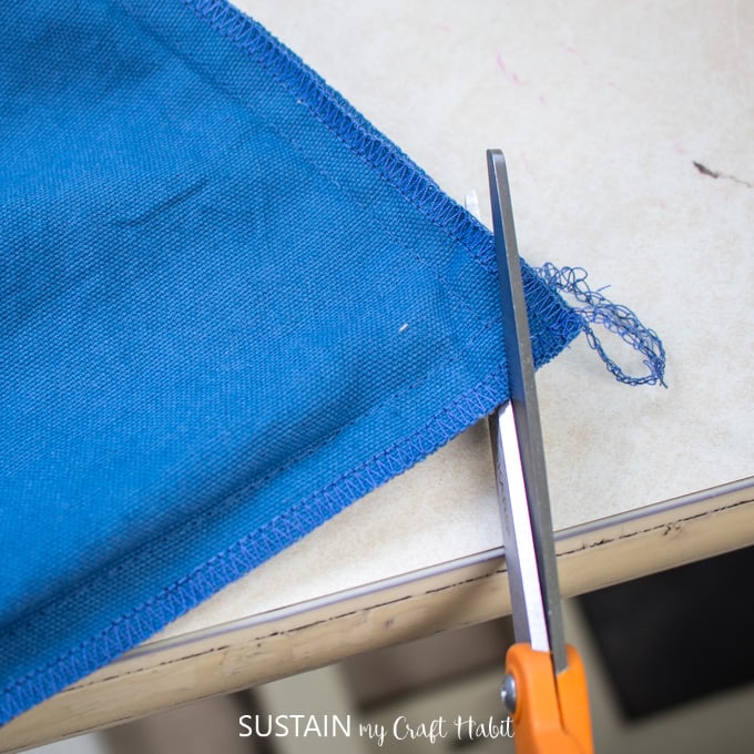 Cutting the corners off from the sewn bag to minimize bulkiness.
